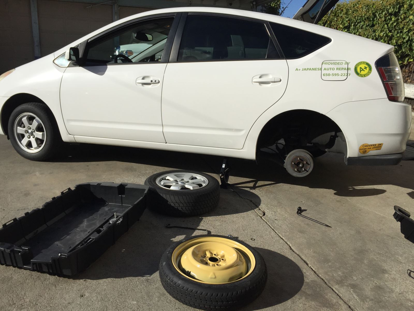 Remove the flat tire and the spare tire