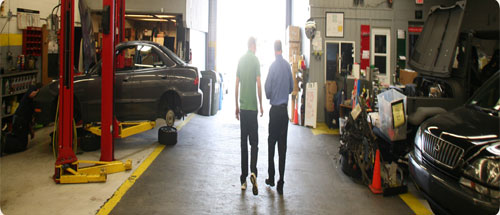 Workers walking through the shop at A+ Japanese Auto Repair in San Carlos, CA
