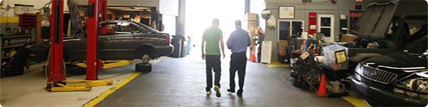 Workers walking through the shop at A+ Japanese Auto Repair in San Carlos, CA